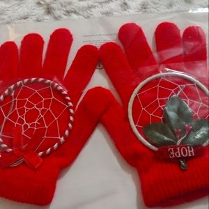 A pair of Red Gloves and 2 Holiday Ornaments that are Dream Catchers